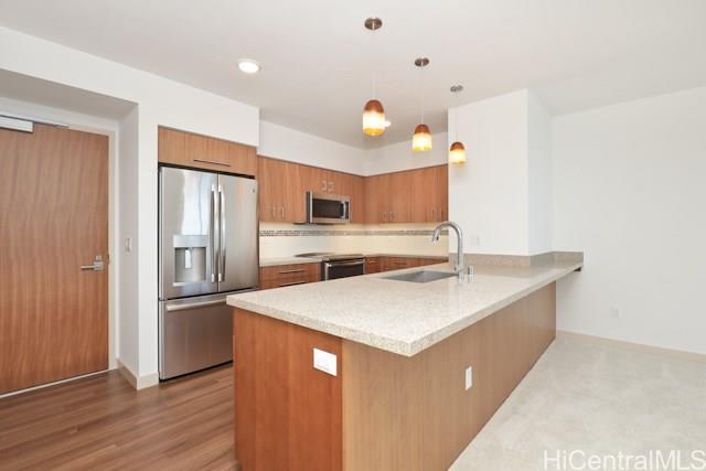 a kitchen with stainless steel appliances a sink and a refrigerator