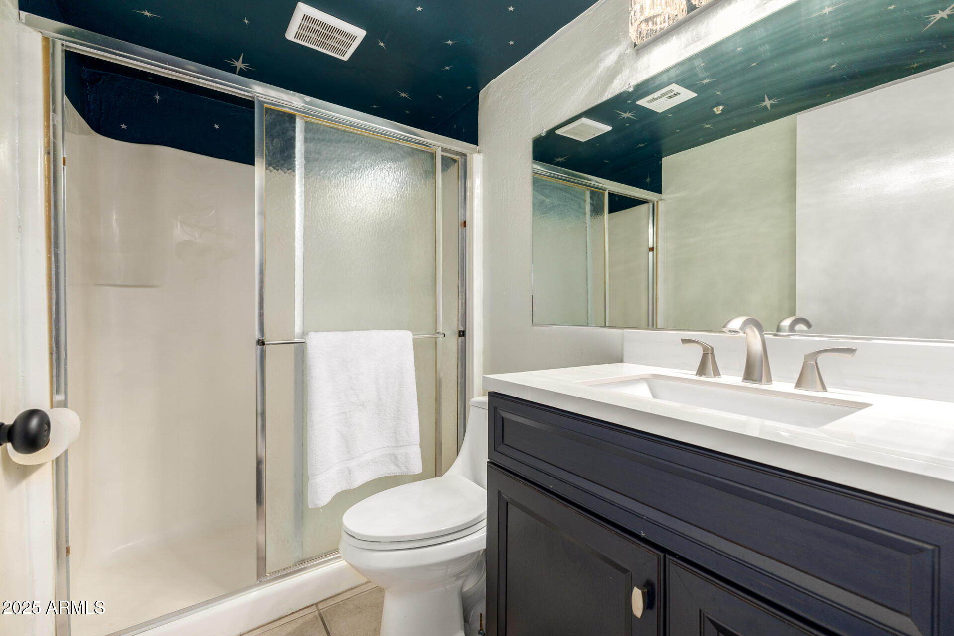 12123 West Bell Road, Unit 110 Surprise, AZ 85378 - Photo 16 of 27 a bathroom with a granite countertop sink a toilet a mirror and shower