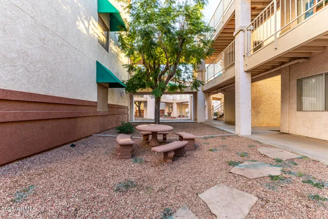 a view of a house with backyard and sitting area