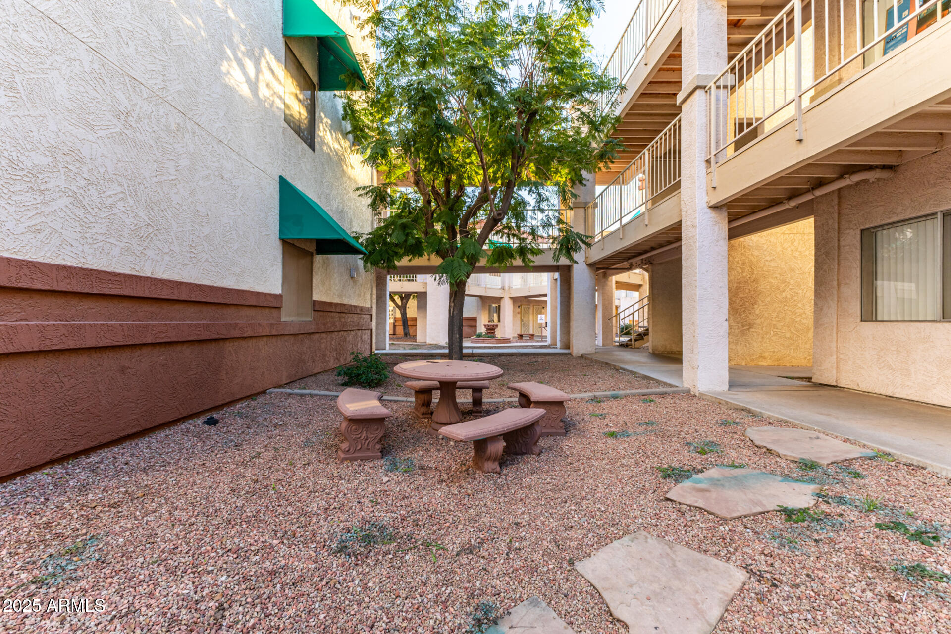 12123 West Bell Road, Unit 110 Surprise, AZ 85378 - Photo 20 of 27 a backyard of a house with fire pit and couches