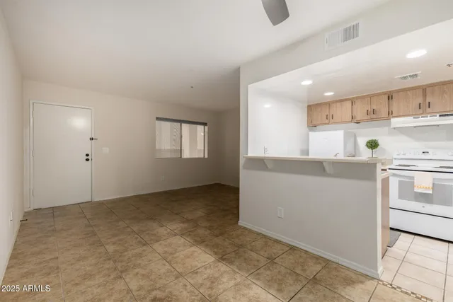 a kitchen with kitchen island sink stove and cabinets