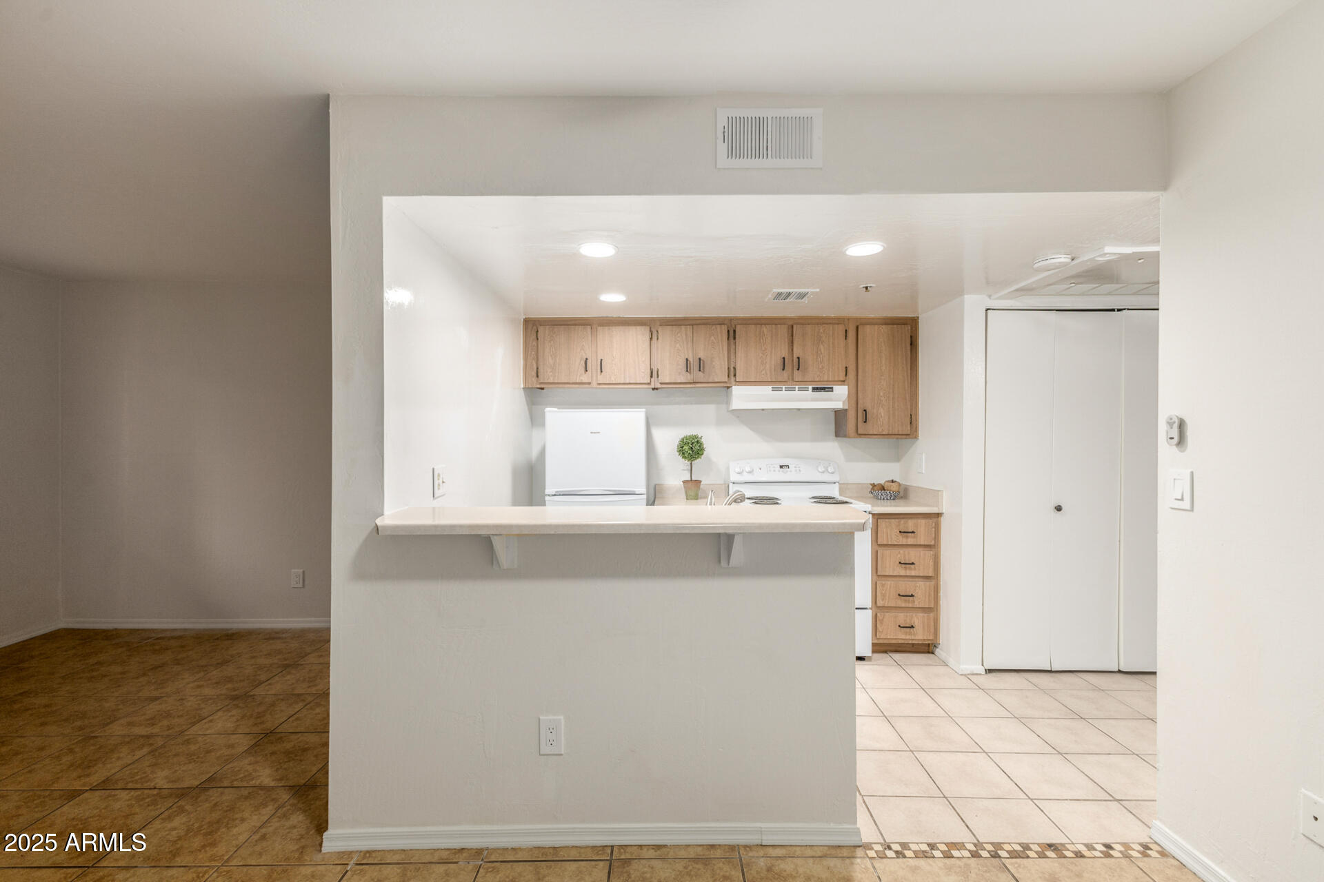 12123 West Bell Road, Unit 110 Surprise, AZ 85378 - Photo 8 of 27 a kitchen with kitchen island sink stove and cabinets