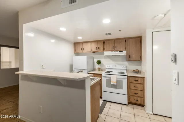 a view of kitchen with center island and stainless steel appliances
