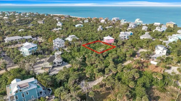an aerial view of a houses with a yard