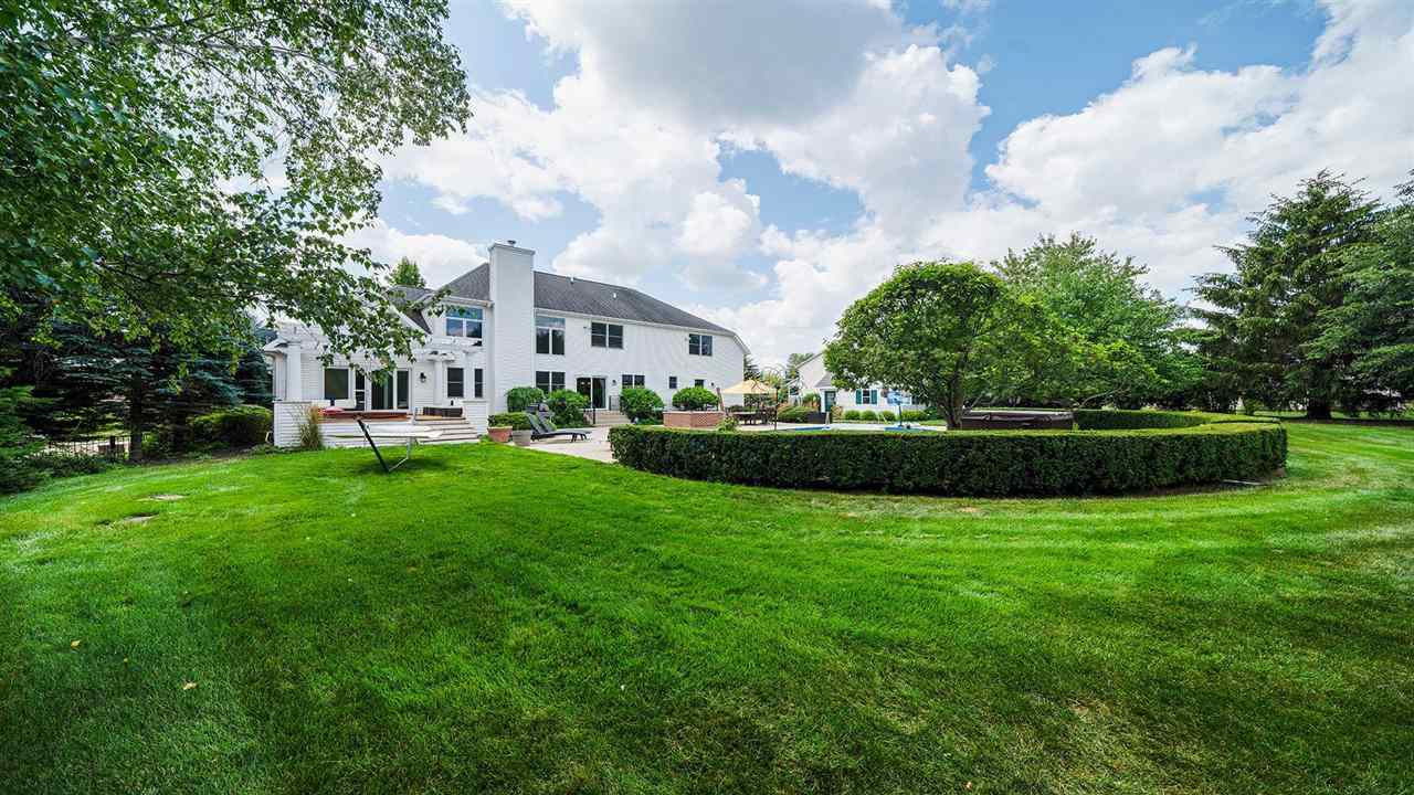 4464 Ridgeview Lane Byron, IL 61010 - Photo 45 of 54 a view of a house with a big yard and potted plants and large trees