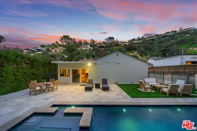 a kitchen with granite countertop wooden cabinets a counter top space and stainless steel appliances