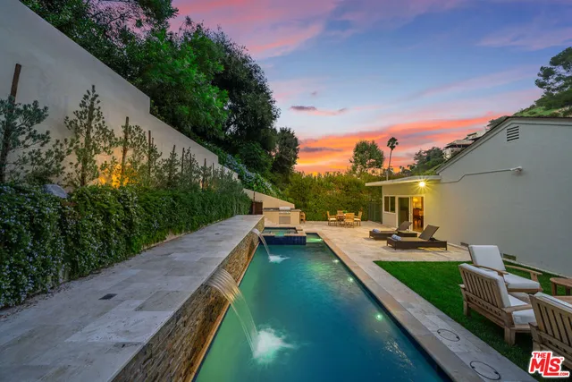 a large kitchen with kitchen island a large window