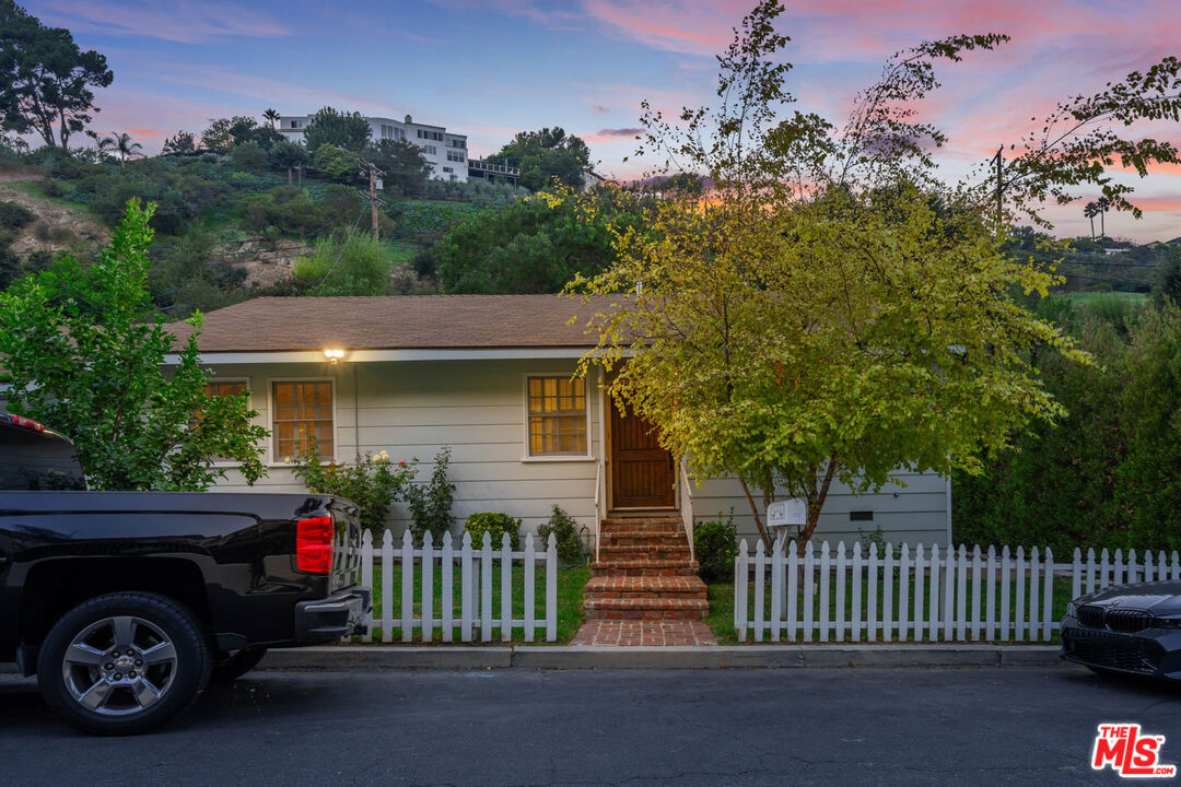 3771 Longview Valley Road Sherman Oaks, CA 91423 - Photo 2 of 75 a front view of a house with a garden and parking