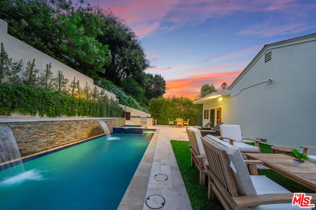 3771 Longview Valley Road Sherman Oaks, CA 91423 - Photo 21 of 75 a view of a swimming pool with a patio