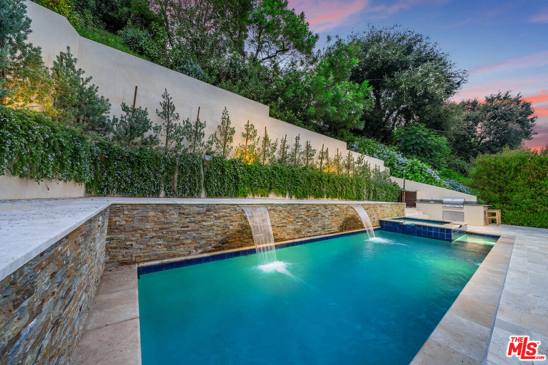3771 Longview Valley Road Sherman Oaks, CA 91423 - Photo 22 of 75 a view of a swimming pool with a patio and a yard