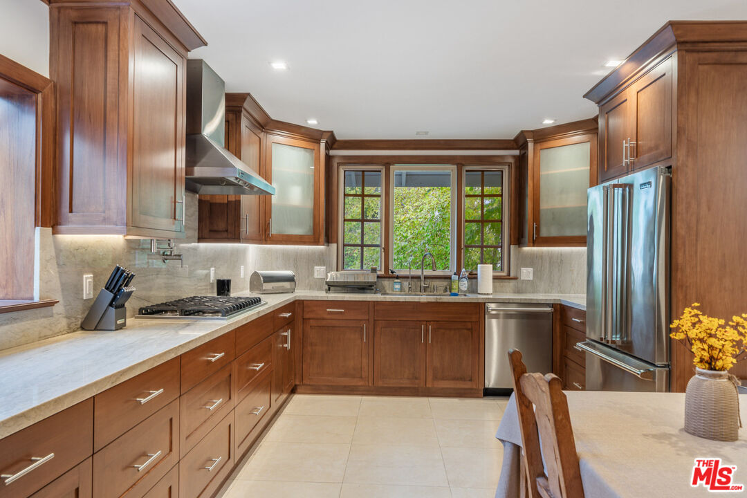 3771 Longview Valley Road Sherman Oaks, CA 91423 - Photo 36 of 75 a kitchen with stainless steel appliances granite countertop a sink stove and refrigerator
