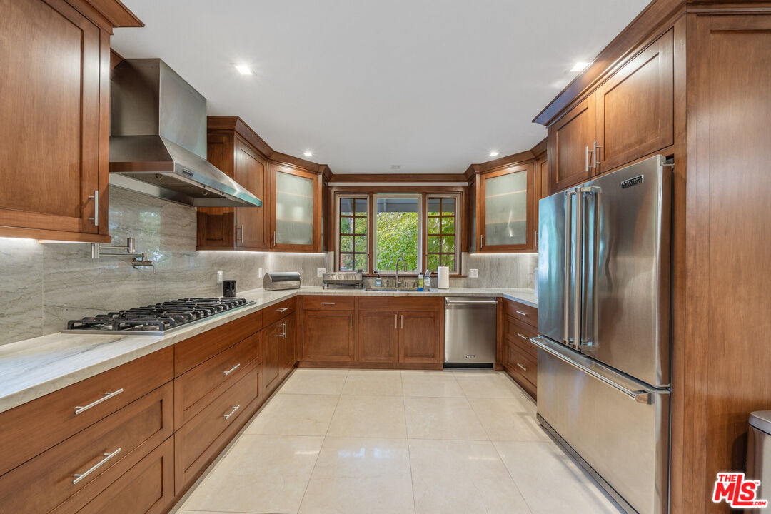 3771 Longview Valley Road Sherman Oaks, CA 91423 - Photo 37 of 75 a large kitchen with stainless steel appliances granite countertop a refrigerator a sink a stove and island