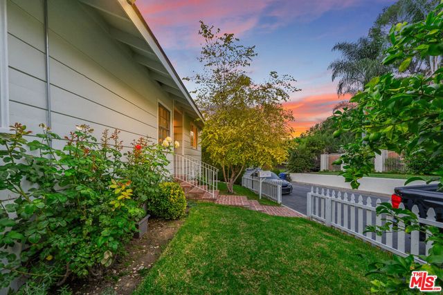 a view of backyard with seating area and green space