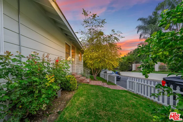 a view of backyard with seating area and green space