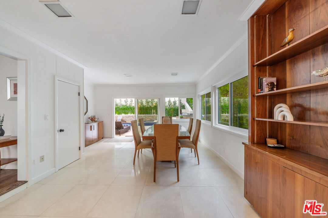 3771 Longview Valley Road Sherman Oaks, CA 91423 - Photo 47 of 75 a dining room with furniture and a floor to ceiling window
