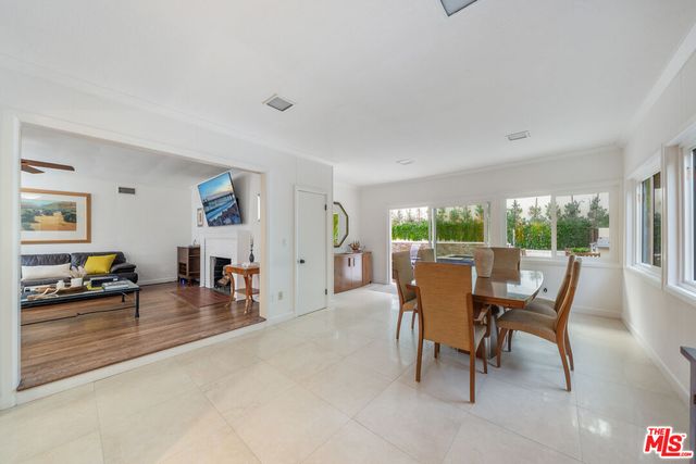a view of a hallway with wooden floor and a living room