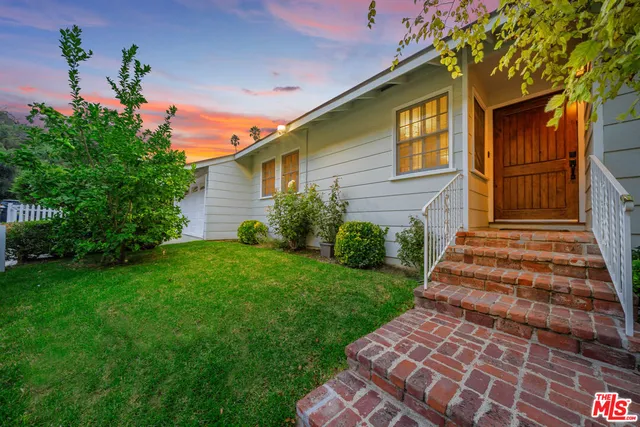 a view of a patio with a table chairs and a backyard