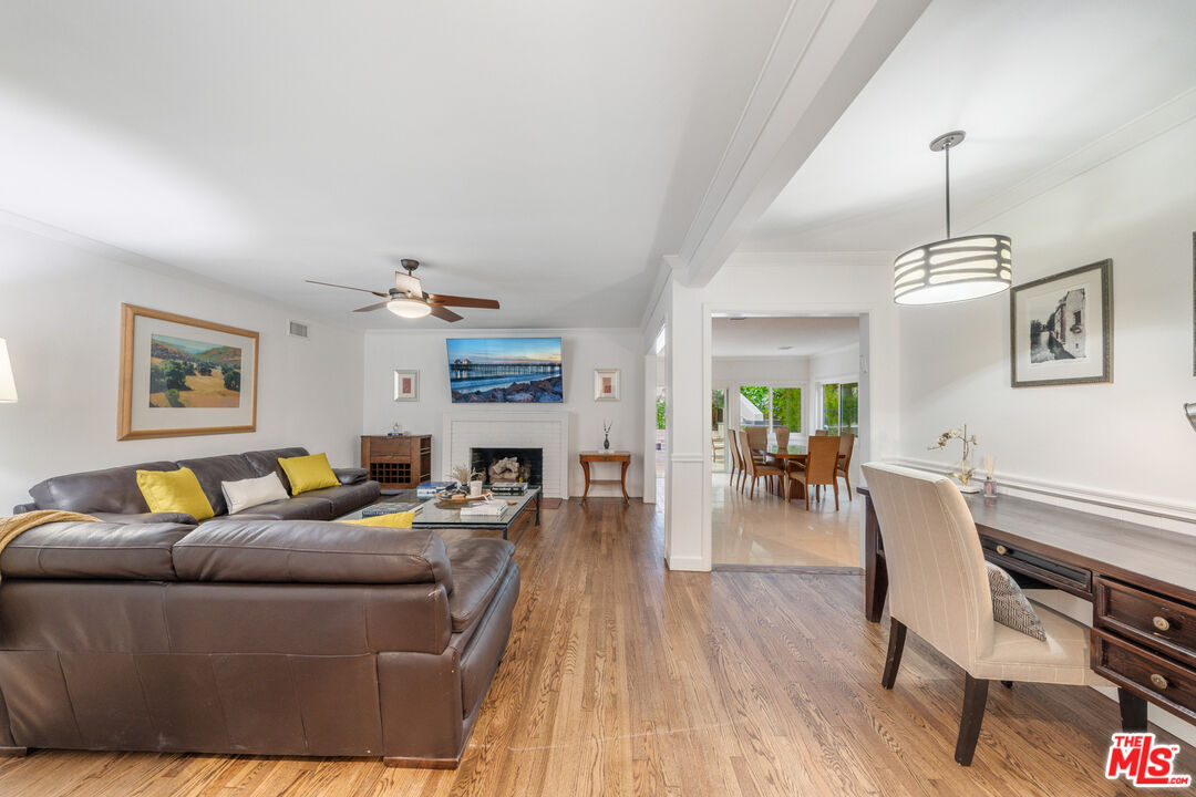 3771 Longview Valley Road Sherman Oaks, CA 91423 - Photo 54 of 75 a living room with furniture a fireplace and wooden floor