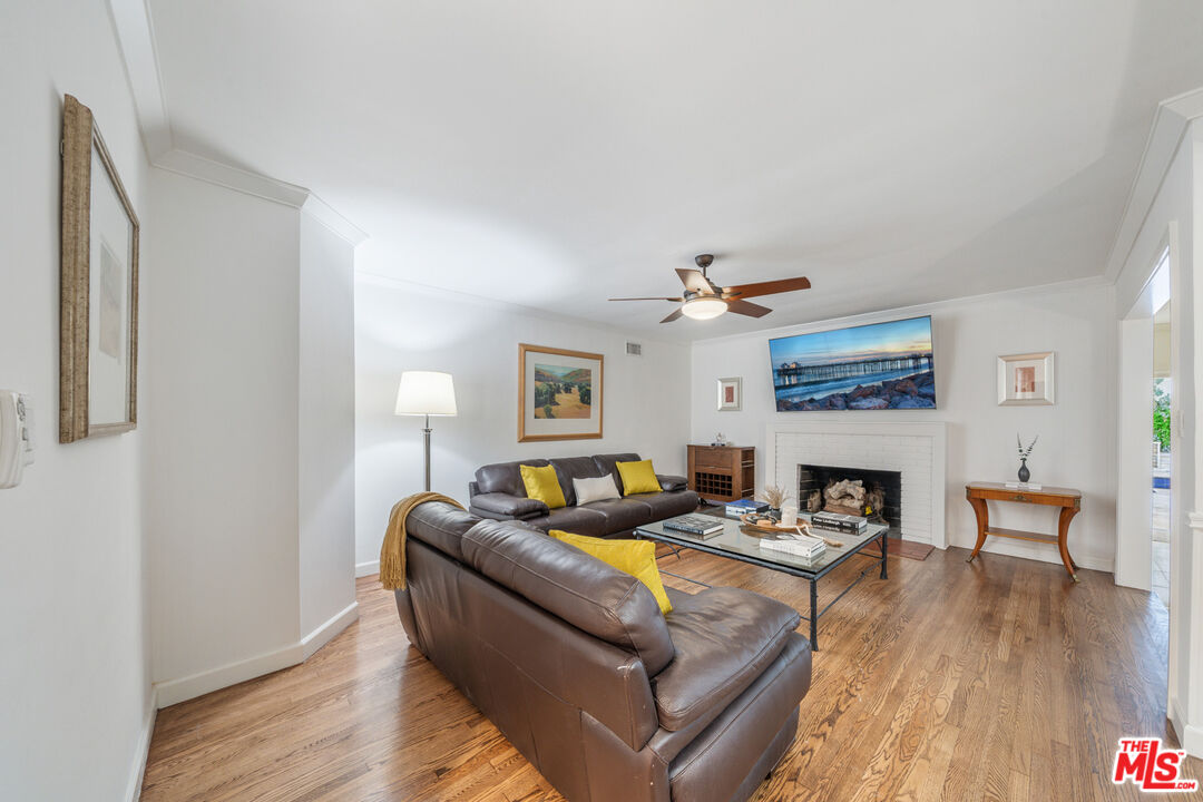 3771 Longview Valley Road Sherman Oaks, CA 91423 - Photo 55 of 75 a living room with furniture and a fireplace