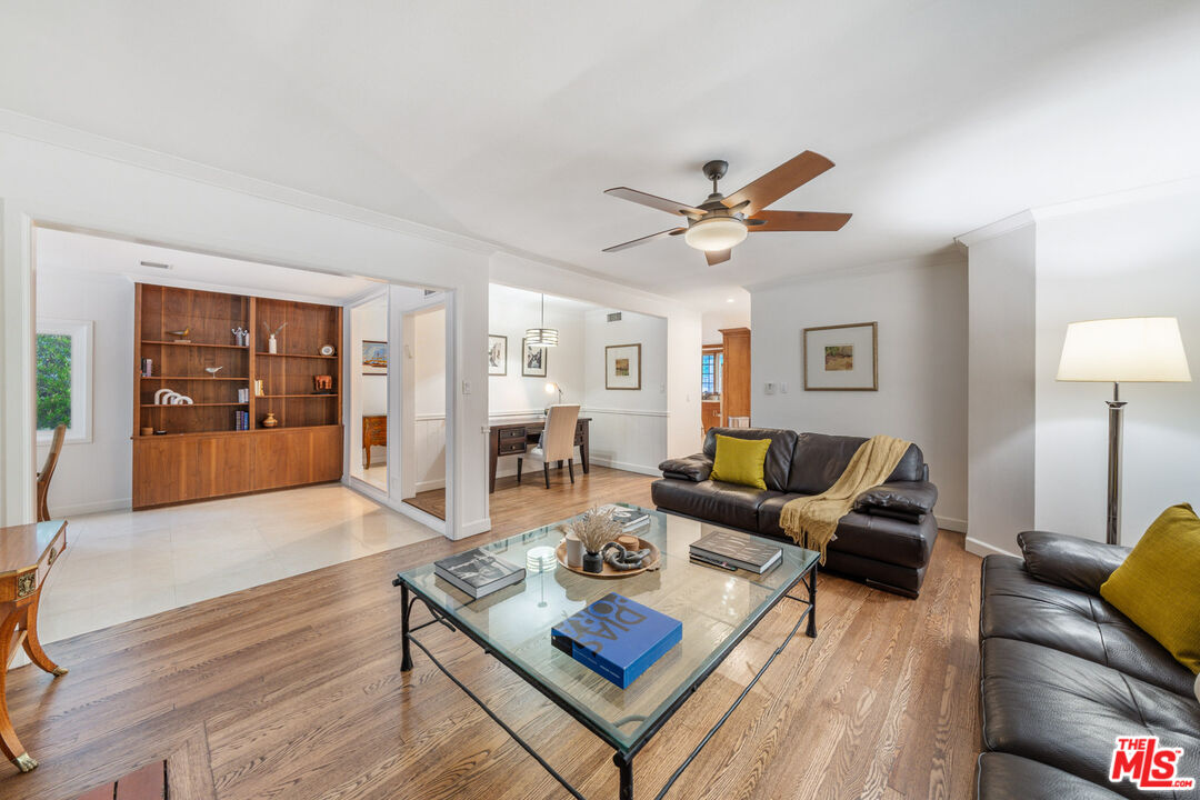 3771 Longview Valley Road Sherman Oaks, CA 91423 - Photo 60 of 75 a living room with furniture a rug and a chandelier