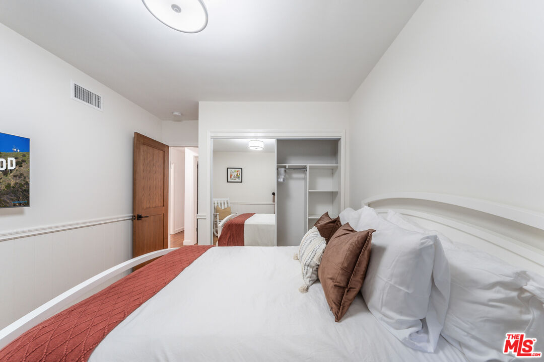 3771 Longview Valley Road Sherman Oaks, CA 91423 - Photo 67 of 75 a bedroom with a bed and chair