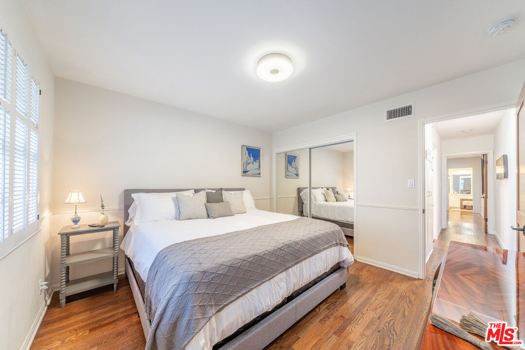 3771 Longview Valley Road Sherman Oaks, CA 91423 - Photo 69 of 75 a bedroom with a bed and a large mirror