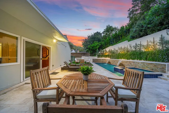 a view of a chairs and table in the patio