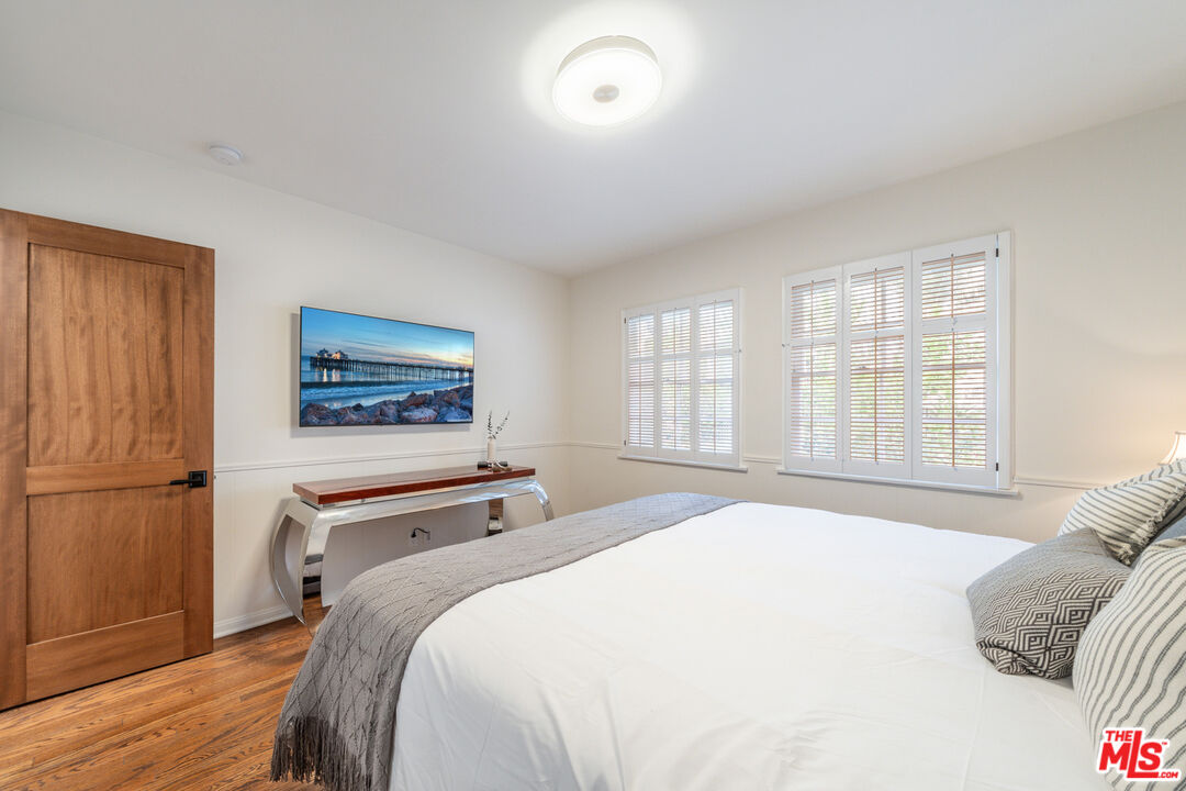 3771 Longview Valley Road Sherman Oaks, CA 91423 - Photo 71 of 75 a bedroom with a bed and a window