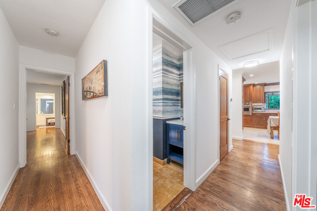 3771 Longview Valley Road Sherman Oaks, CA 91423 - Photo 72 of 75 a view of a hallway with wooden floor and a living room