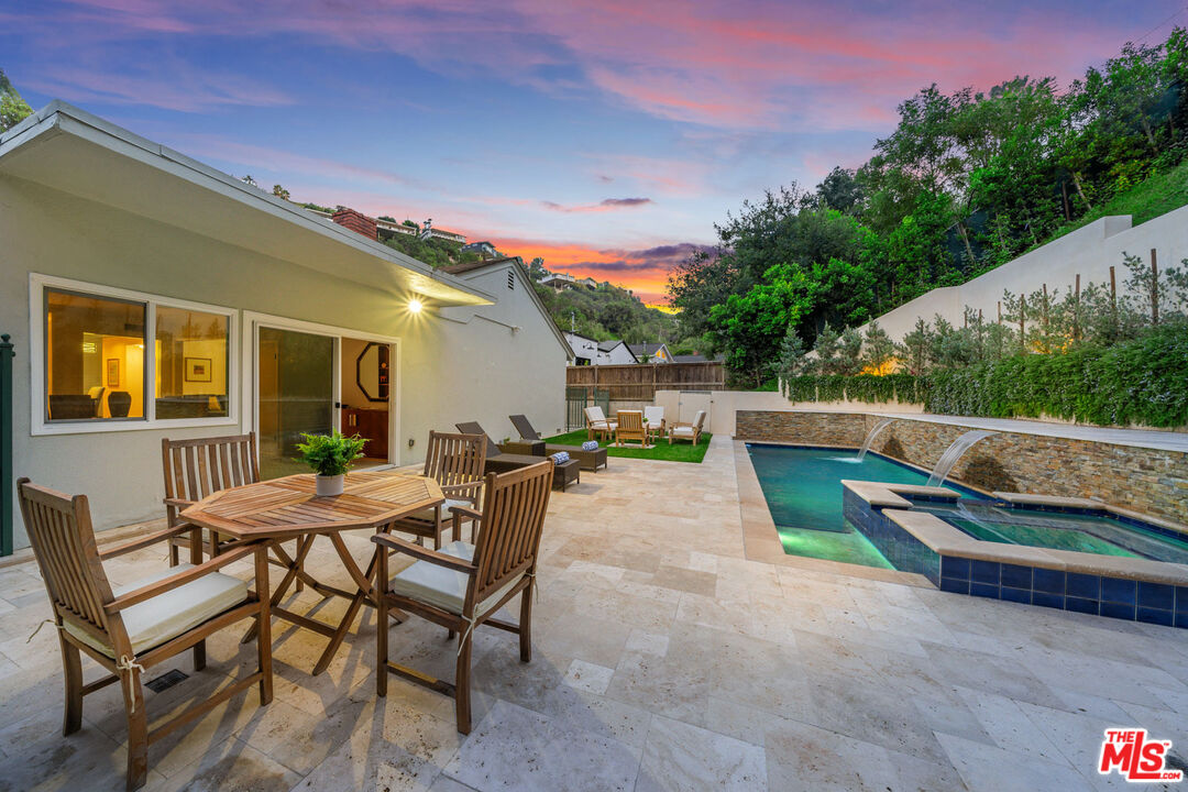 3771 Longview Valley Road Sherman Oaks, CA 91423 - Photo 8 of 75 a view of backyard with table and chairs and wooden fence