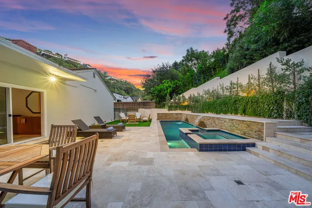 a view of a house with backyard and sitting area
