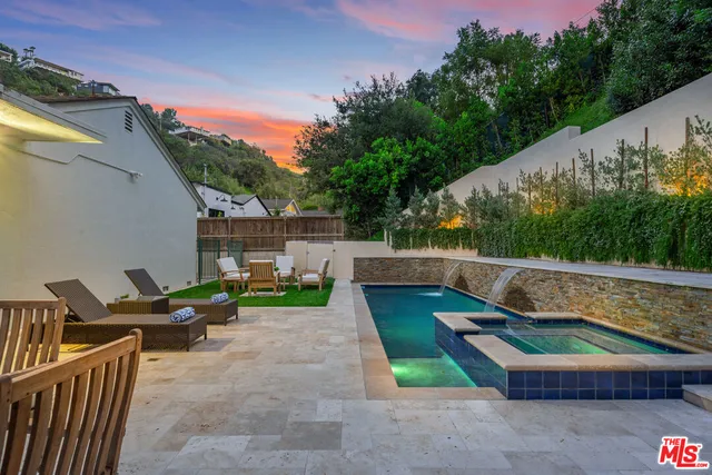 a view of a house with pool and chairs
