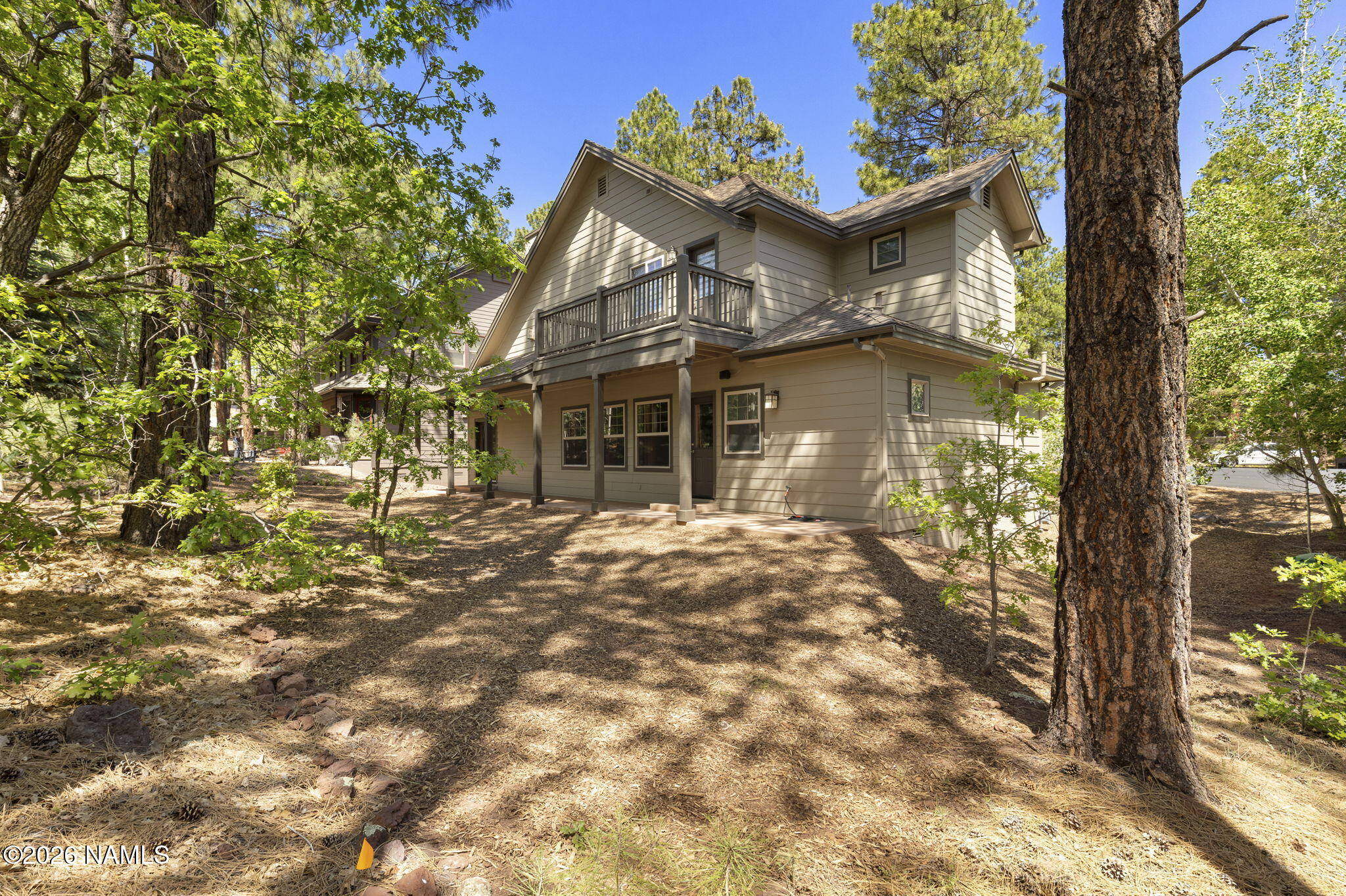 3495 West Lead Rope Flagstaff, AZ 86005 - Photo 38 of 49 a view of a white house next to a tree