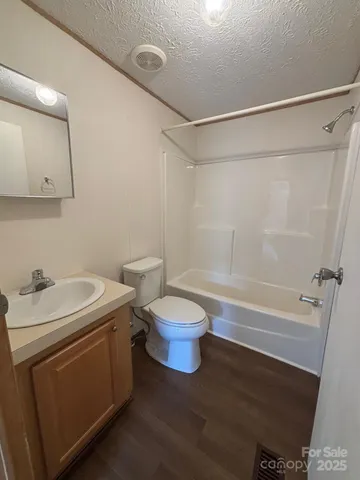 a bathroom with a sink a toilet and a shower