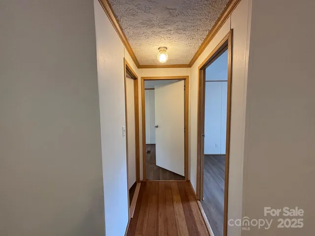 a view of hallway with wooden floor