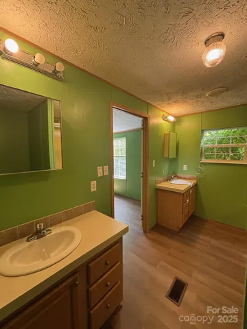 a bathroom with a double vanity sink mirror and toilet