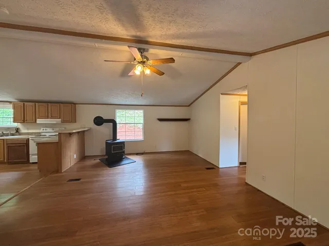 a view of a kitchen with a sink and dishwasher kitchen view with wooden floor