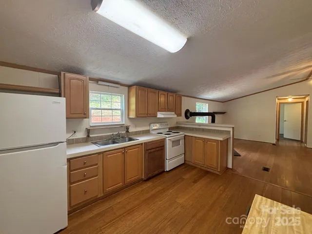 a kitchen with a sink stove and refrigerator