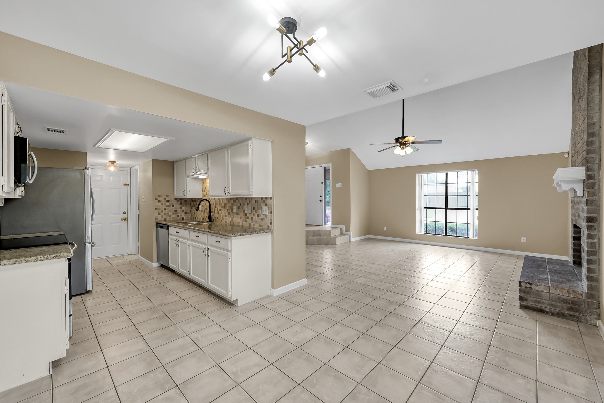 16906 Timberwork Road Spring, TX 77379 - Photo 11 of 36 a large white kitchen with a stove a sink and a refrigerator