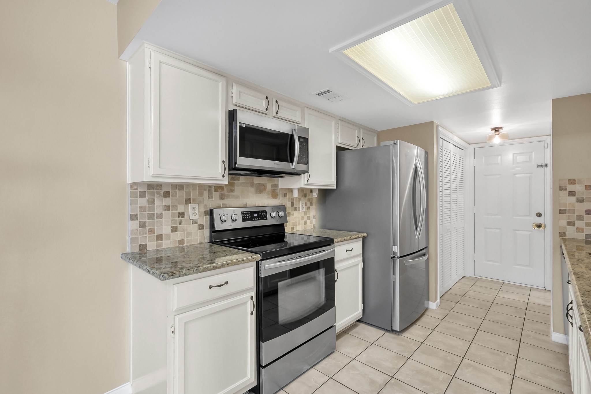 16906 Timberwork Road Spring, TX 77379 - Photo 12 of 36 a kitchen with a refrigerator stove and microwave