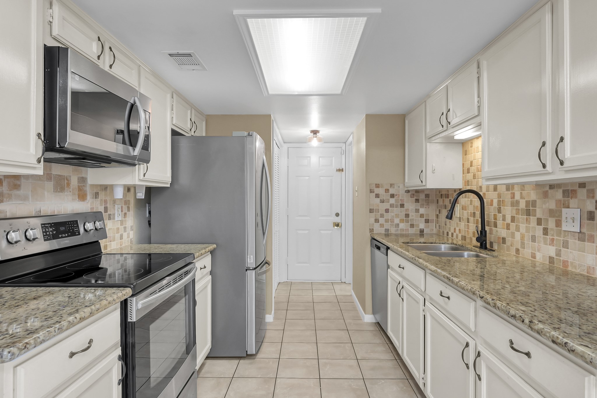 16906 Timberwork Road Spring, TX 77379 - Photo 13 of 36 a kitchen with stainless steel appliances granite countertop a sink stove and refrigerator