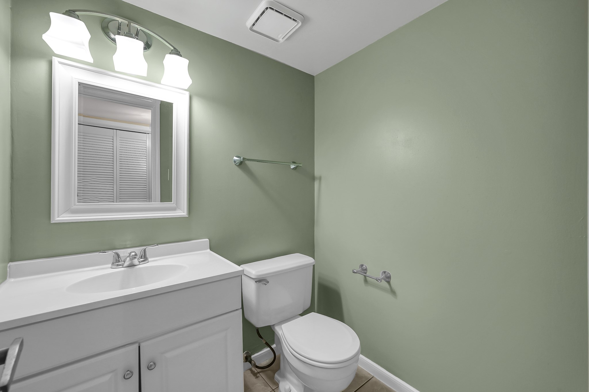 16906 Timberwork Road Spring, TX 77379 - Photo 17 of 36 a bathroom with a toilet a sink a mirror and a window