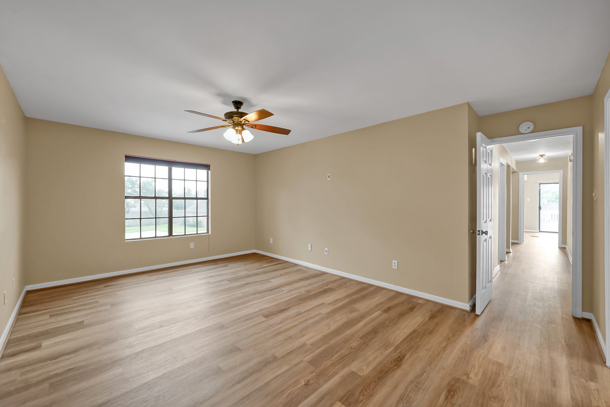 16906 Timberwork Road Spring, TX 77379 - Photo 20 of 36 a view of an empty room with wooden floor and a window