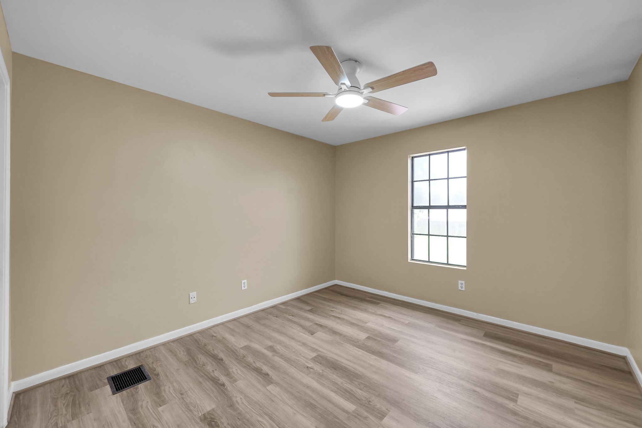 16906 Timberwork Road Spring, TX 77379 - Photo 24 of 36 an empty room with wooden floor fan and windows
