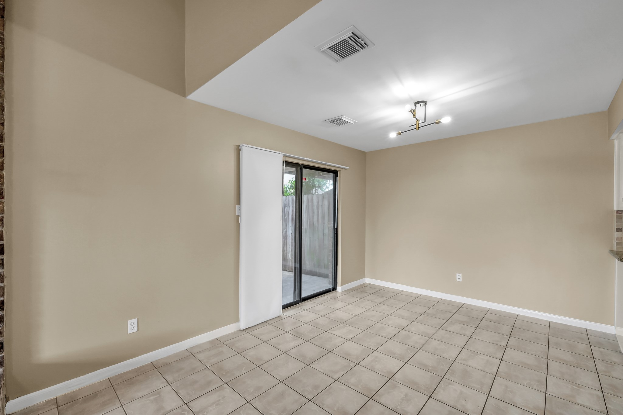 16906 Timberwork Road Spring, TX 77379 - Photo 9 of 36 a view of an empty room with a chandelier fan
