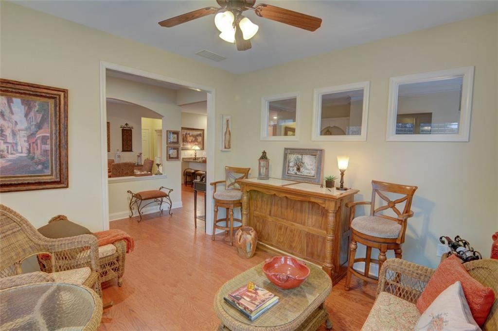 910 Brook Knoll Lane Cumming, GA 30041 - Photo 12 of 36 a living room with furniture and a dining table