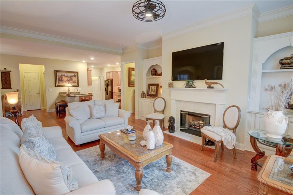 910 Brook Knoll Lane Cumming, GA 30041 - Photo 14 of 36 a living room with furniture a flat screen tv and a fireplace