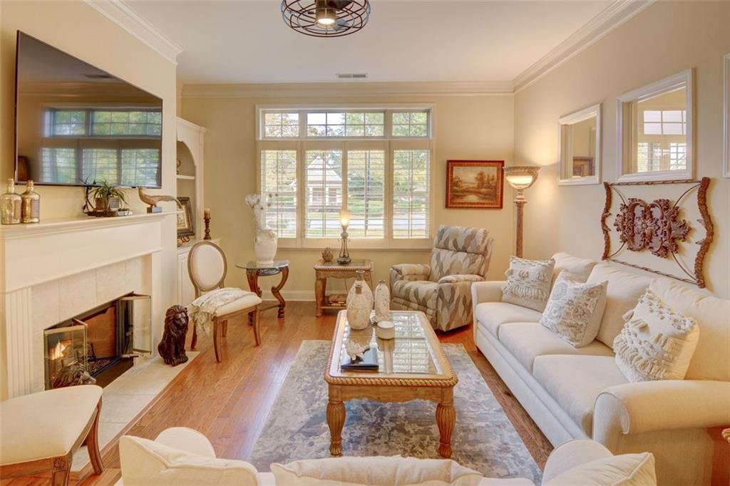 910 Brook Knoll Lane Cumming, GA 30041 - Photo 16 of 36 a living room with furniture fireplace and a large window