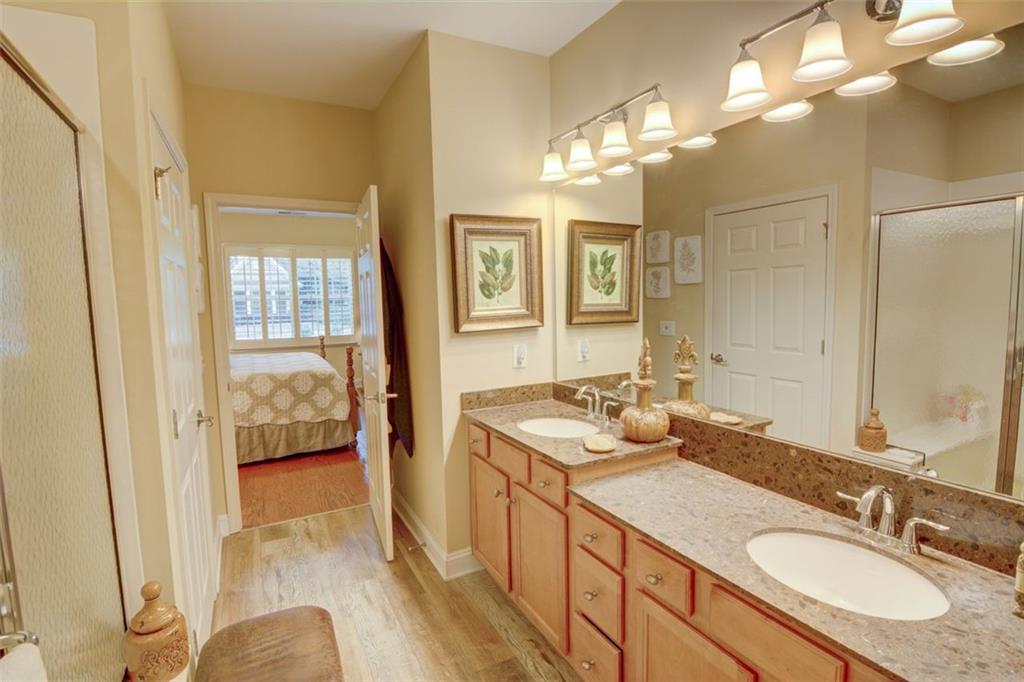 910 Brook Knoll Lane Cumming, GA 30041 - Photo 25 of 36 a bathroom with a sink double vanity granite and a mirror
