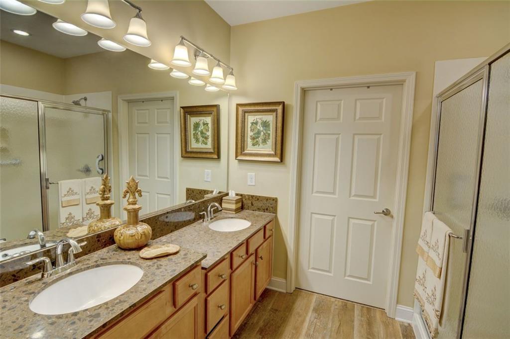 910 Brook Knoll Lane Cumming, GA 30041 - Photo 26 of 36 a bathroom with a sink double vanity granite tub and shower